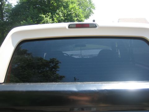1995 Ford Bronco - Rear view of a white SUV, showing the tinted rear window and black tailgate with a Supermotors.net watermark.