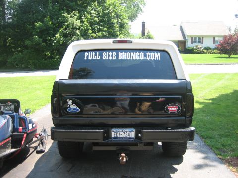 1995 Ford Bronco - The rear of a Ford Bronco is shown, a sticker on the back window and a Ford logo on the tailgate.