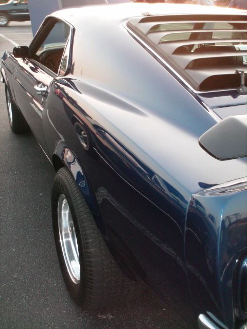 1970 Ford Mustang - Classic car side profile with hood up. Appears to be a 1969 model.