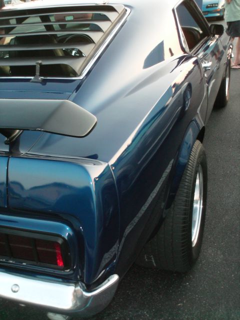 1970 Ford Mustang - The rear of a blue 1970 Ford Mustang is shown, louvers and a spoiler.