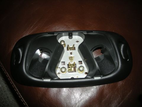 1986 Ford Bronco - Close-up of a disassembled interior light fixture, showing the electrical contacts and mounting points.