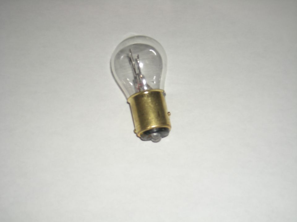 clear glass light bulb with a brass base