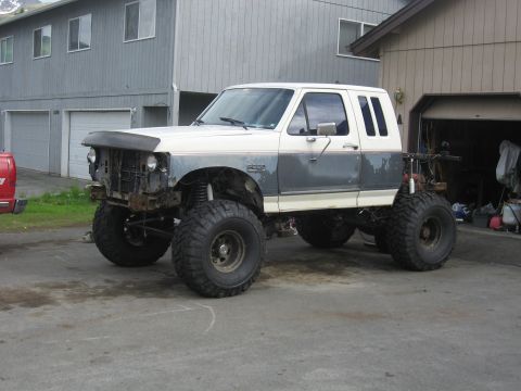 1990 Ford F-250 - This modified 1990 Ford F-250 features a significant lift kit and massive tires, ready for off-road adventures.