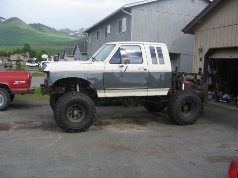 1990 Ford F-250 - Modified 1990 Ford F-250 pickup truck with lifted suspension and oversized tires.