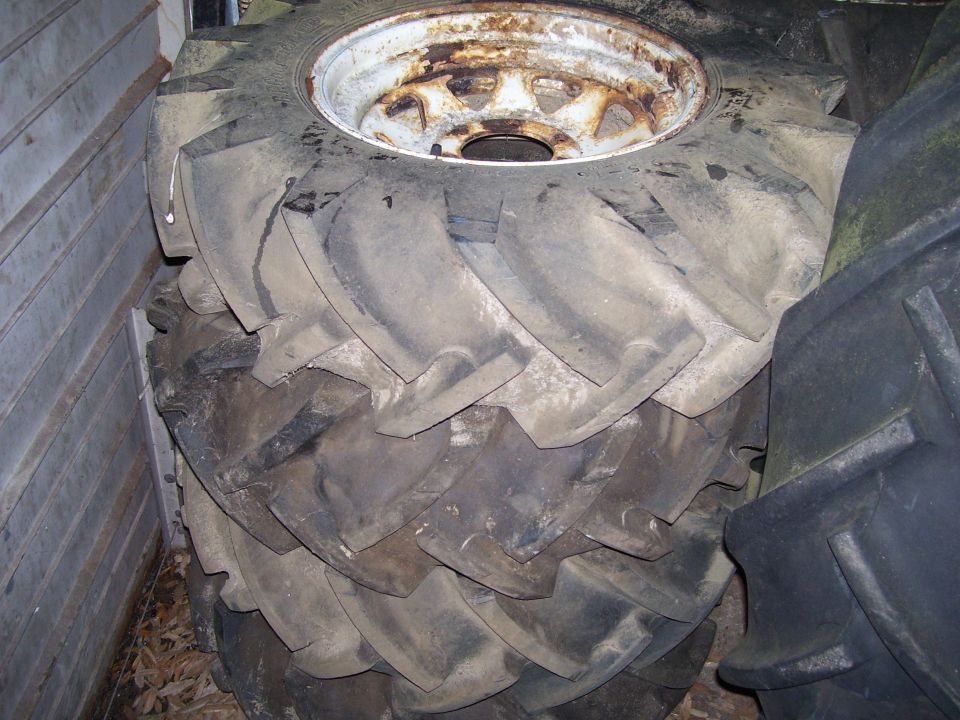 Stack of large tractor tires with rusty rims