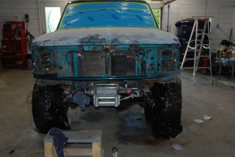 1996 Ford Bronco - 1996 Ford Bronco undergoing bodywork and repair in a garage setting.
