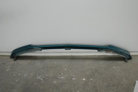 1996 Ford Bronco - A teal front bumper is shown from the front, resting on a concrete floor.