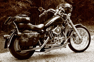 2005 Ford Crown Victoria - A motorcycle with saddlebags and a windshield is parked outdoors.