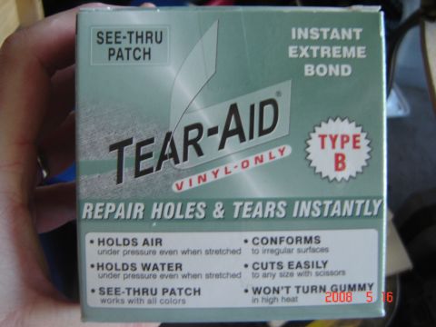 1993 Ford Bronco - A box of Tear-Aid vinyl repair patches is held in a hand, displaying product information and usage instructions.