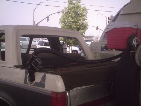 1991 Ford Bronco - This 1991 Ford Bronco has a hose connected to its fuel filler, with a cooler in the bed.
