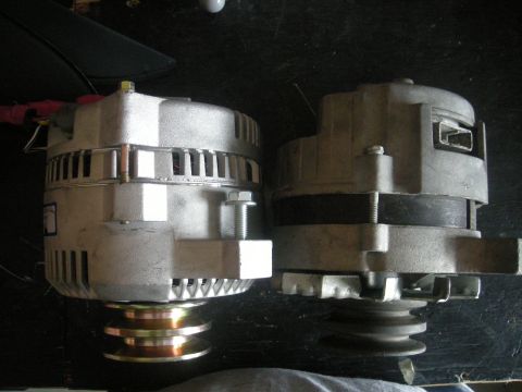 1986 Ford Bronco - Comparison of two alternators, with one a distinct yellow and copper pulley system.