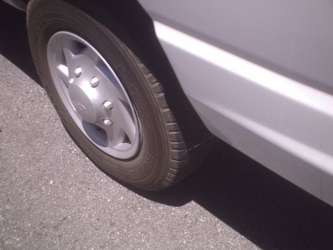 1991 Ford Bronco - Side view of a vehicle's wheel and body panel.