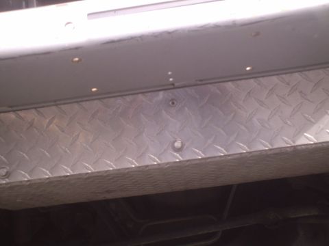 1991 Ford Bronco - Close-up of diamond plate trim installed on the lower body of a vehicle.