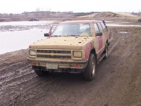 1972 Pontiac Grand Prix - This SUV is covered in mud, suggesting it has been off-roading in a wet, muddy environment.