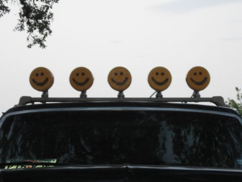 1990 Ford Bronco - This vehicle is equipped with a roof rack five yellow 'DAYLIGHTER' lights, each designed with a smiley face.
