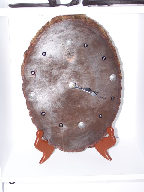 1995 Ford C-350 (Centurion Conversions) - A clock made from a slice of wood, with metal accents and a stand.