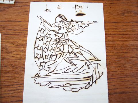 1995 Ford C-350 (Centurion Conversions) - This wood burning artwork depicts a soldier in uniform holding a rifle, with the American flag draped around them.