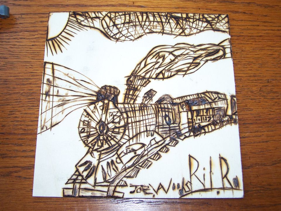 Wood burning art of a steam train with smoke and sun