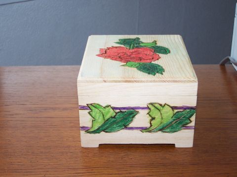 1995 Ford C-350 (Centurion Conversions) - A decorative wooden box sits on a table, adorned with a rose and leaf design.