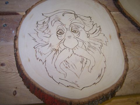 1995 Ford C-350 (Centurion Conversions) - Wood slice art depicts an old man's face with intricate line work for his beard and hair.