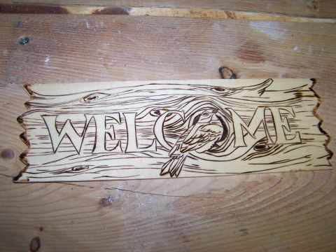 1995 Ford C-350 (Centurion Conversions) - Wood carving of the word WELCOME, a bird perched on the letters.