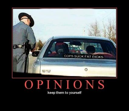 2000 Mercury Grand Marquis - A police officer approaches a car with a controversial sticker on its rear window.