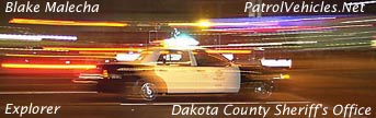 1972 Pontiac Grand Prix - Dakota County Sheriff's Office Explorer patrol vehicle captured in motion at night.