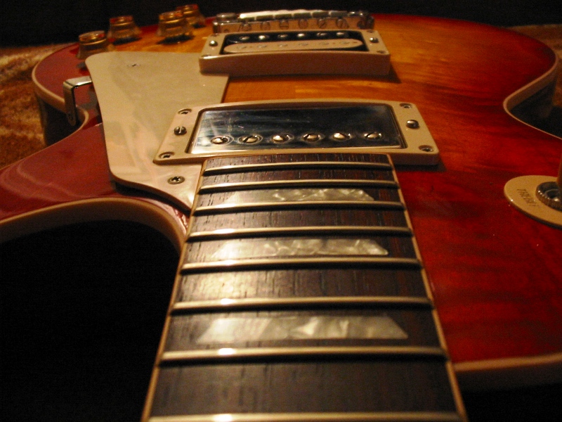 Close-up of an electric guitar's fretboard and pickups