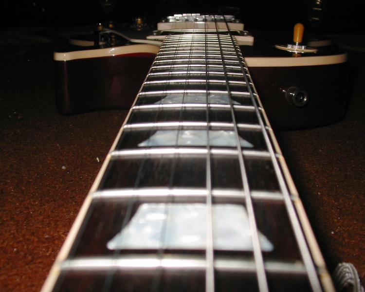 Close-up of an electric guitar's fretboard and strings
