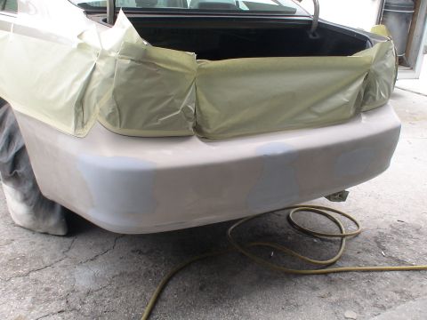 1993 Ford C-350 (Centurion Conversions) - Car's rear bumper is masked off and has primer applied, ready for paint work.