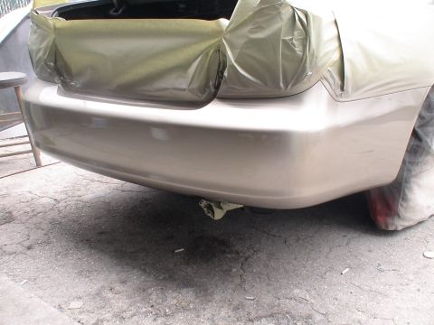 1993 Ford C-350 (Centurion Conversions) - The rear of a car is masked off and appears to be in the process of being repainted.