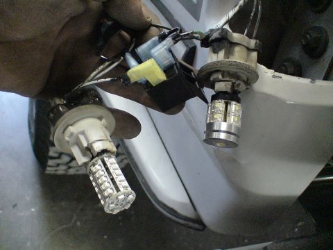 1993 Ford C-350 (Centurion Conversions) - LED bulbs are being installed into a vehicle's lighting system, replacing older bulbs.