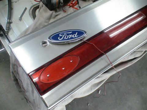 1993 Ford C-350 (Centurion Conversions) - Close-up of a 1993 Ford tailgate emblem and taillight assembly, showing wiring details.