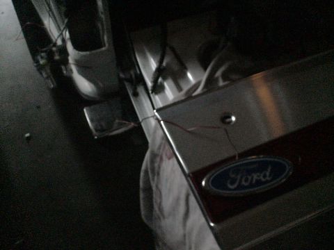 1993 Ford C-350 (Centurion Conversions) - The Ford emblem is visible on the tailgate, with some wiring exposed nearby.
