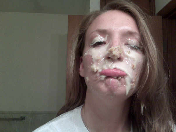 woman with food smeared on her face, eyes closed, lips pursed