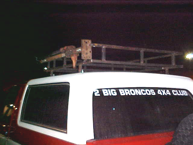 SUV with custom metal roof rack, has '2 BIG BRONCOS 4X4 CLUB' sticker on rear window