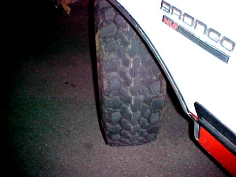 1987 Ford Bronco - Close-up of the fender and tire on a 1987 Ford Bronco.