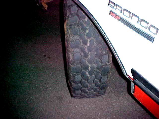 1987 Ford Bronco fender with "BRONCO" badge and off-road tire