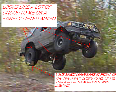 1987 Ford Bronco - This truck is airborne, with its front end high and suspension showing significant droop.