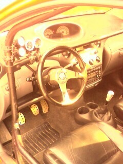 2002 Nissan SE-R - Customized interior features a roll cage, auxiliary gauges, and performance pedals.