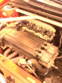 2002 Nissan SE-R - Close-up of a Nissan SR20DE engine, showing the valve cover and intake manifold.