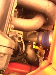 2002 Nissan SE-R - Close-up view of engine parts, including hoses and a dipstick, with a website logo at the bottom.