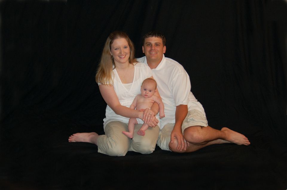Family portrait with mother, father, and baby.