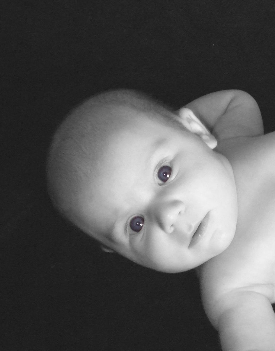 Black-and-white portrait of an infant baby looking at the camera