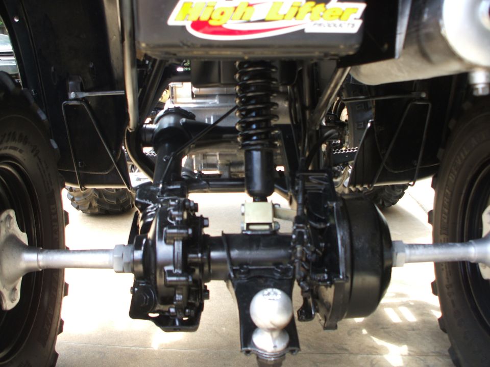 Underside rear view of black ATV with differential, axles, coil-over shock and trailer hitch