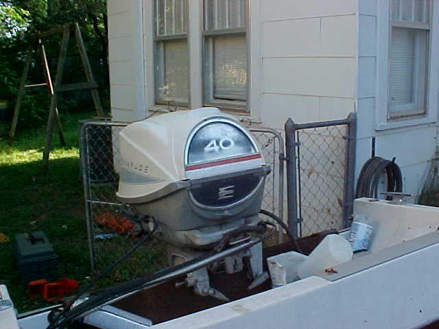 Outboard boat motor with '40' visible on the cowl, mounted on a boat