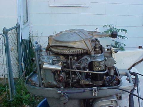 1987 Ford Bronco - An outboard motor is shown in detail, with a fence and building in the background.