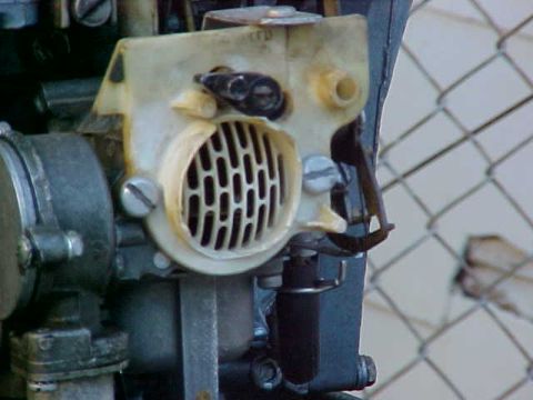 1987 Ford Bronco - Detail of an engine component, possibly from a vehicle, with a visible grille and control knob.