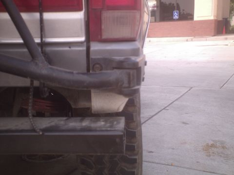 1991 Ford Bronco - The rear of a 1991 Ford Bronco is visible, with a spare tire mount and leaf springs clearly seen.