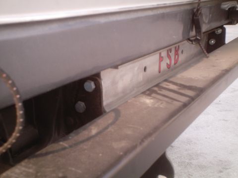 1991 Ford Bronco - Metal bracket with red text 'FSB' attached to a vehicle frame.